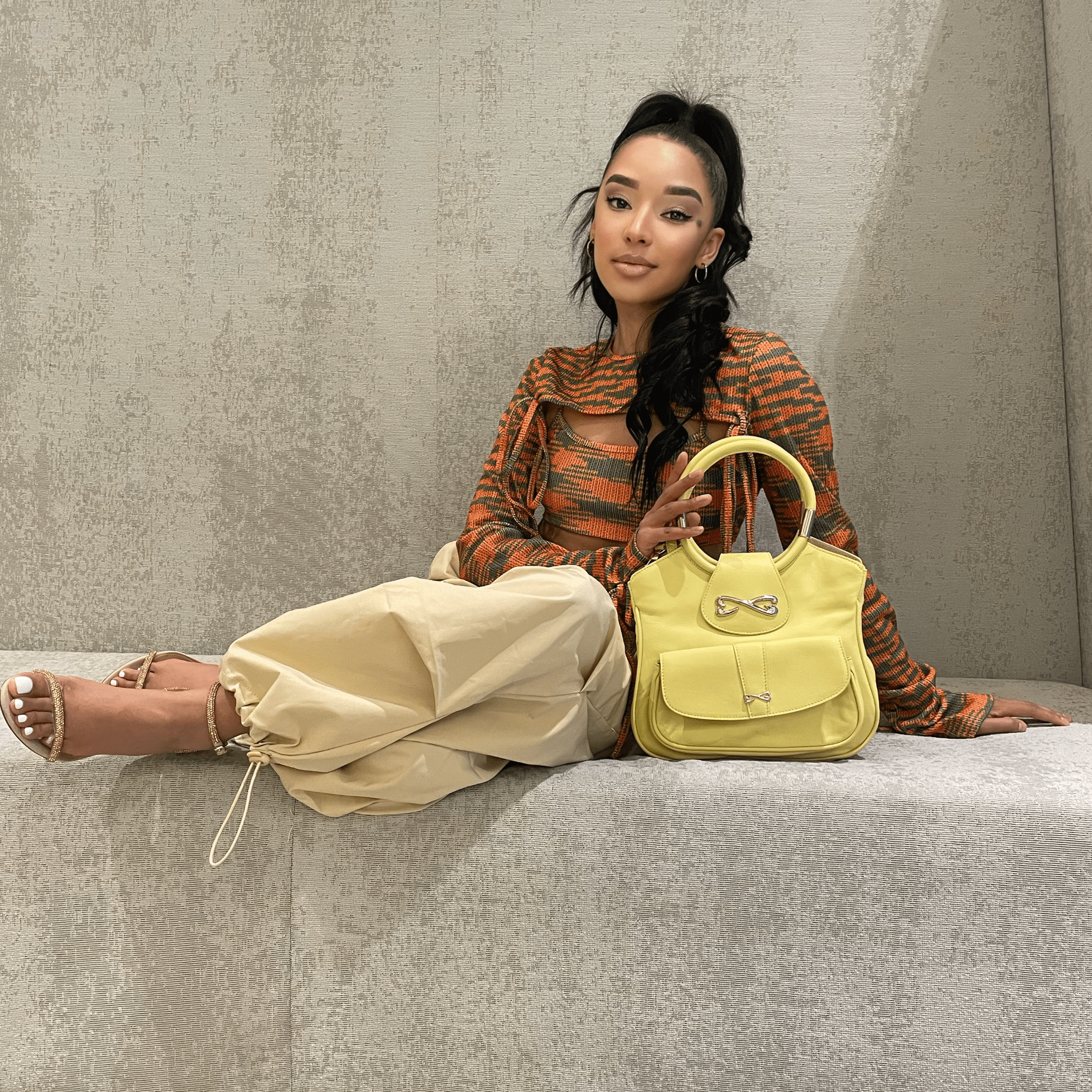 model wearing unique yellow medium leather handbag