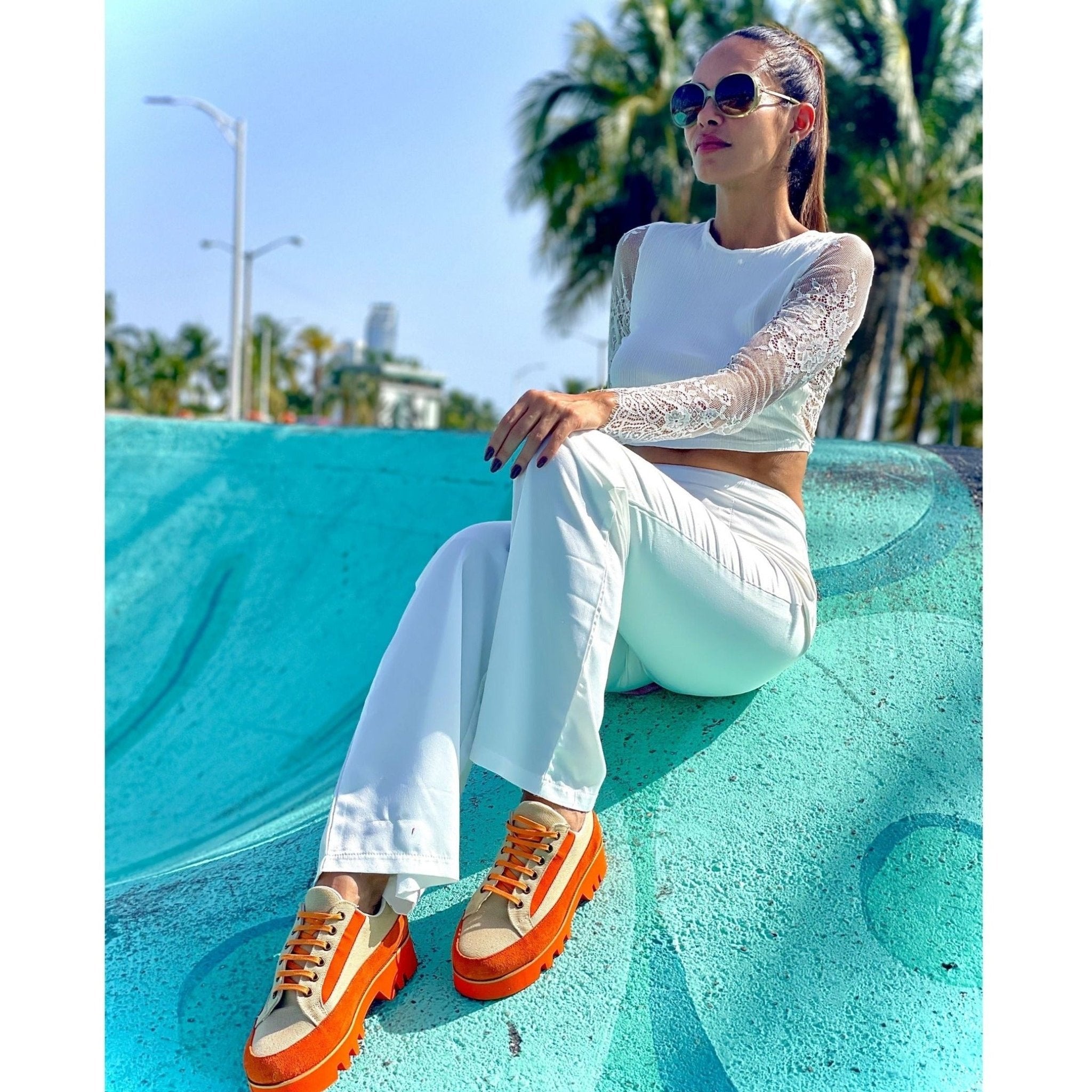 woman wearing orange canvas suede sneaker